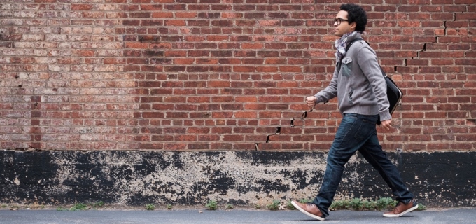 Male with laptop bag walking to work